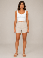 White slim-fit sleeveless tank top with V neckline and twisted front detail