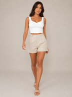 White slim-fit sleeveless tank top with V neckline and twisted front detail