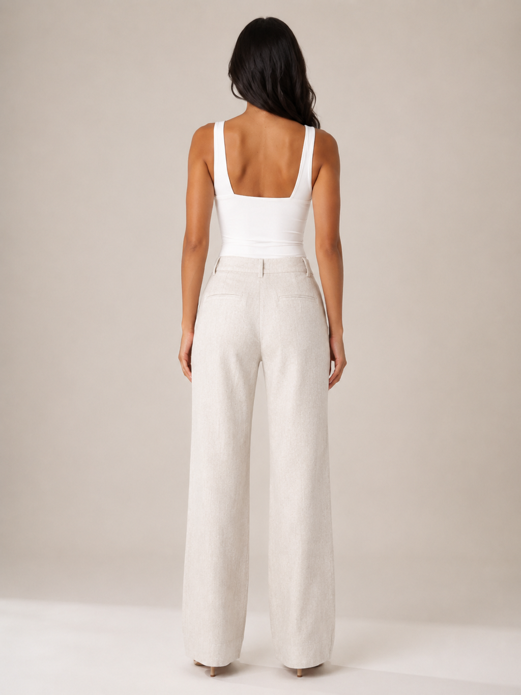 White sleeveless top with straight back and fitted seam at waist