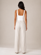 White sleeveless top with straight back and fitted seam at waist