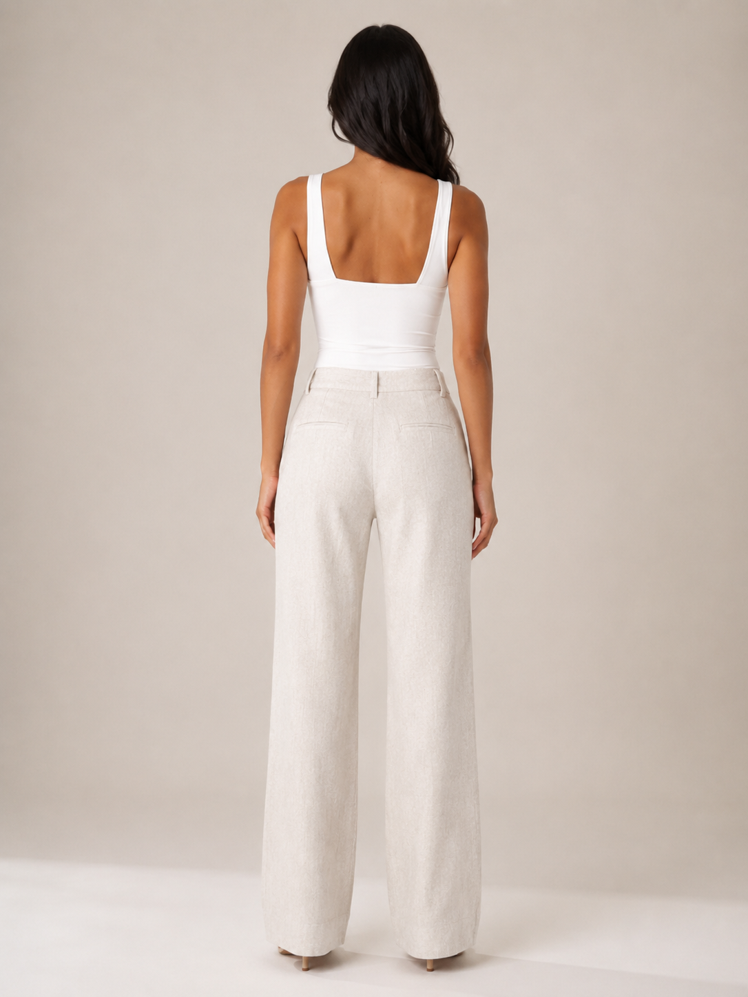 White sleeveless top with straight back and fitted seam at waist