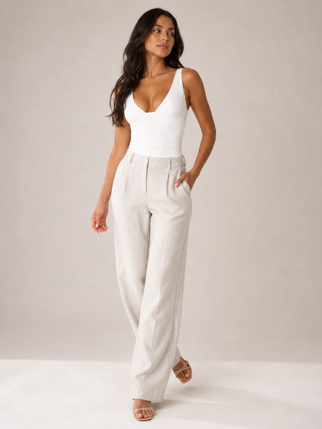 White fitted sleeveless V-neck top with contoured bust and smooth finish