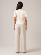 Cream satin slim-fit short-sleeve top with lace-trim back neckline and short gathered sleeves