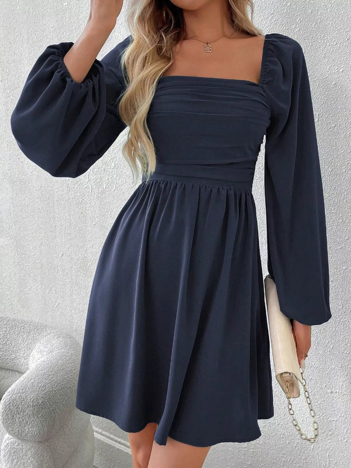 Navy A-line dress with ruched square neckline and long puff sleeves