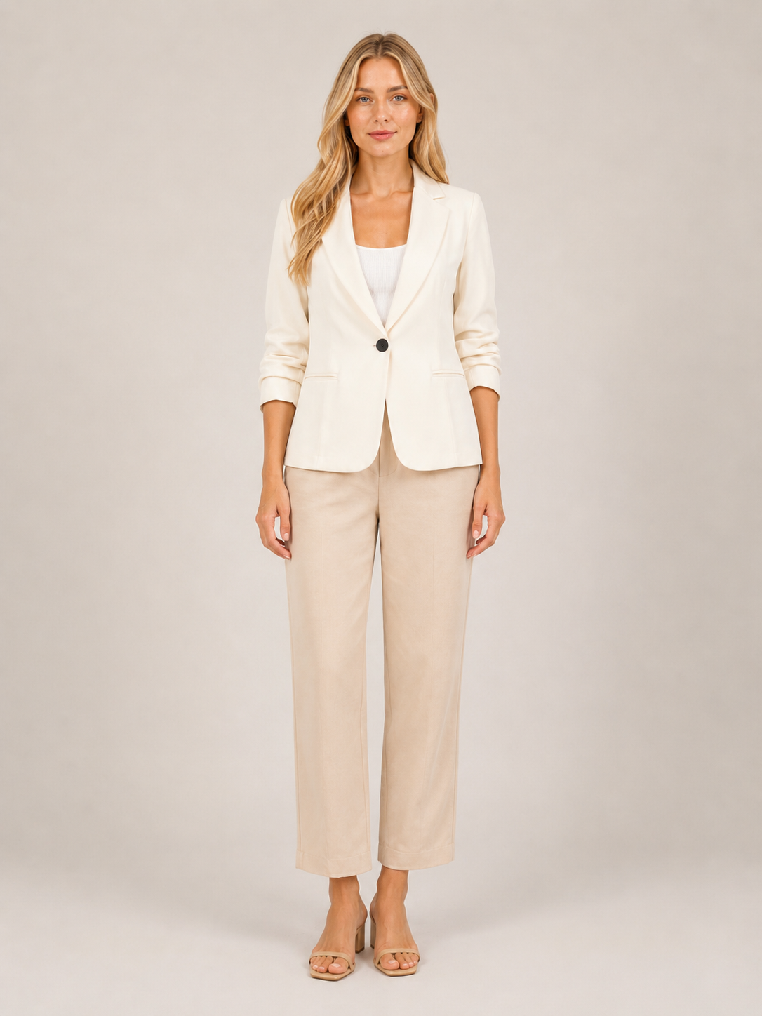 Cream one-button tailored women’s blazer with notched lapel, front view