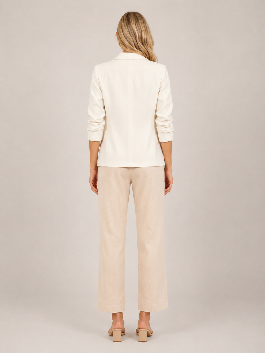Cream one-button tailored women’s blazer, back view with three-quarter sleeves