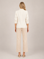 Cream one-button tailored women’s blazer, back view with three-quarter sleeves