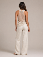 Sabria halter top in beige shown from back with open-back drape