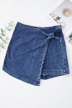 Blue acid-wash denim skort, wrap-front design with stitched side panel