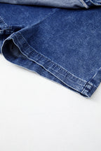 Blue acid-wash denim skort hem with visible seam stitching and folded edge