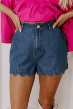 High-waist blue denim shorts with scalloped hem, front button, and belt loops