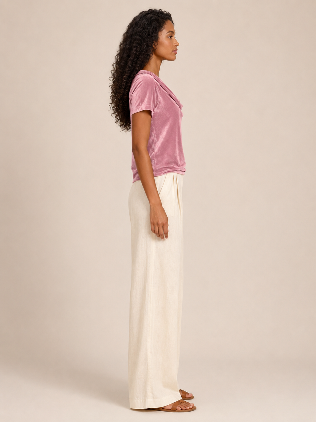 Pink velvet top with waterfall cowl neck and short sleeves, side profile.