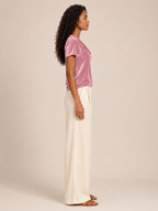 Pink velvet top with waterfall cowl neck and short sleeves, side profile.