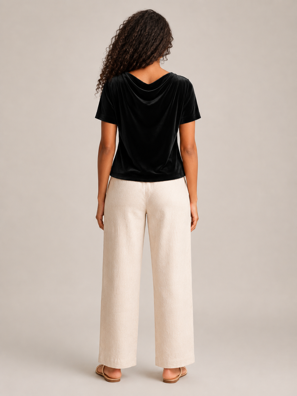 Black velvet top with draped waterfall neckline and short sleeves, back view.
