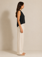 Black sleeveless V-neck blouse with pleat detail, side profile