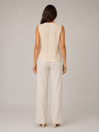 Back view of soft apricot sleeveless blouse with smooth yoke panel