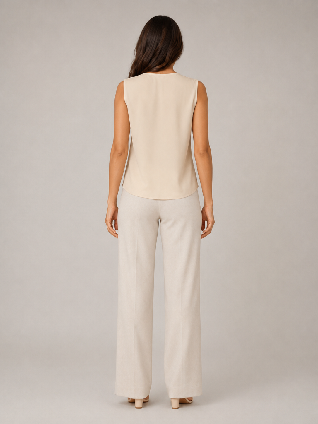 Back view of soft apricot sleeveless blouse with smooth yoke panel