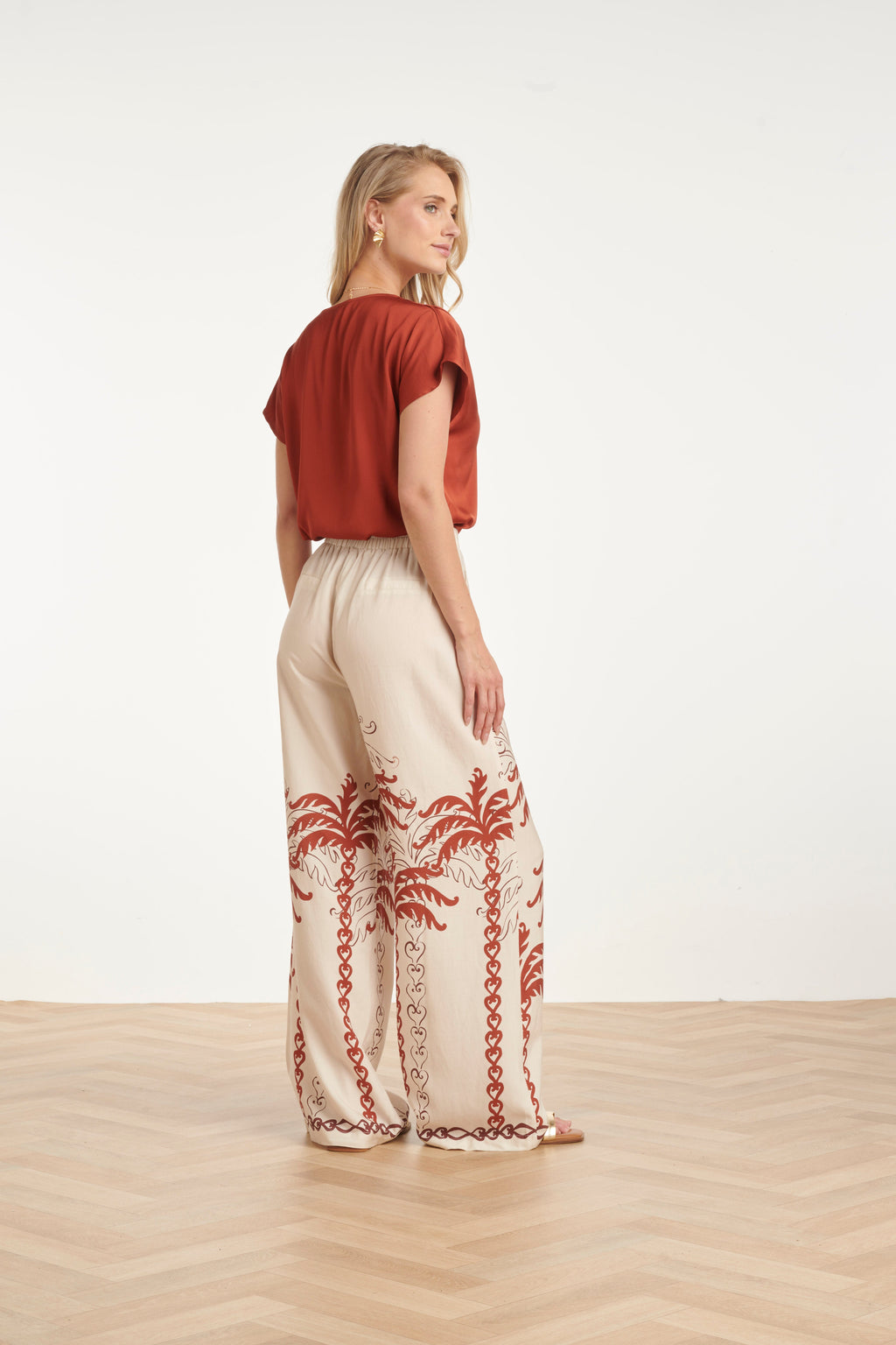 Brick satin short-sleeve blouse back view, neat V-neckline trim