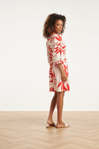 White dress with red floral print, side view with tie waist and three-quarter sleeves