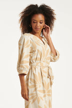 Off-white floral V-neck dress with three-quarter puff sleeves and cinched waist tie