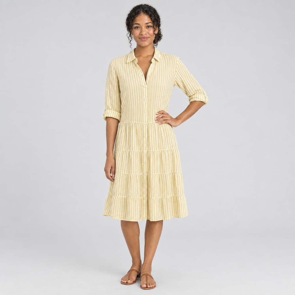 Yellow striped tiered shirt dress on model, hand on hip, rolled sleeves