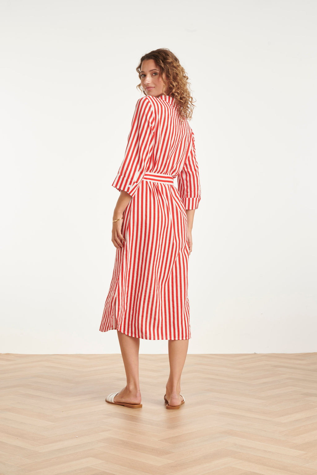 Red and white striped belted maxi dress with three-quarter sleeves, midi hem