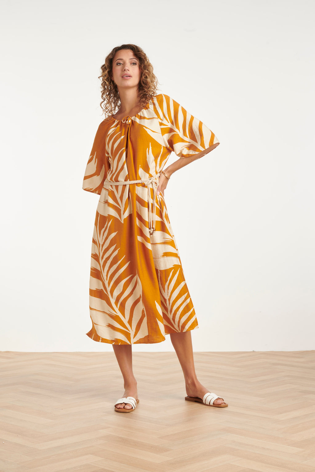 Mustard tunic dress with off-white tropical leaf print and tied adjustable waist