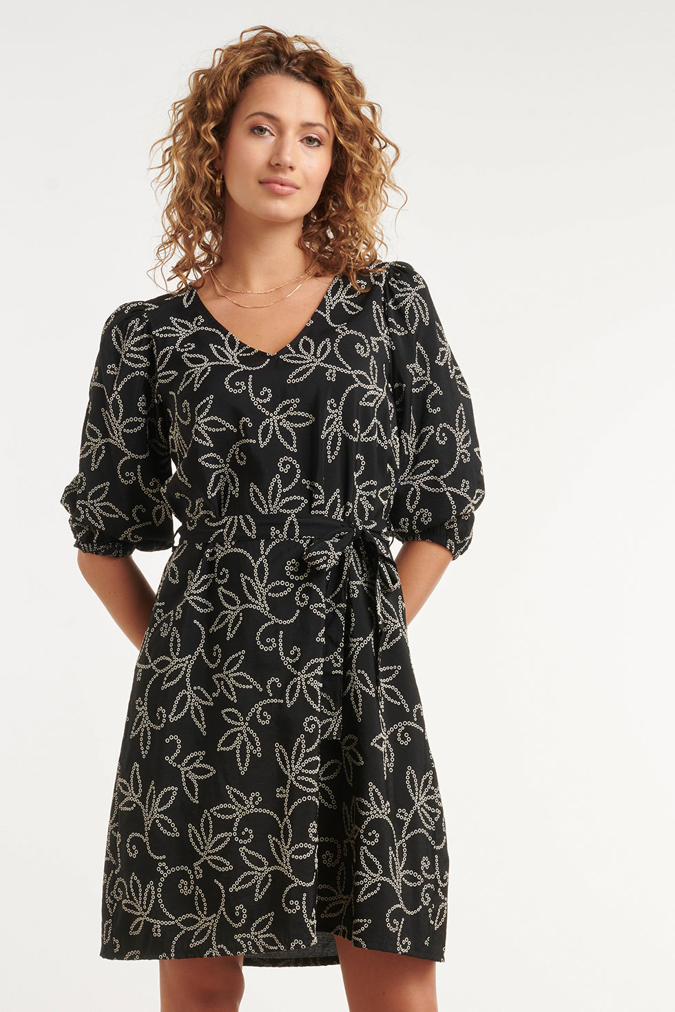 Black V-neck floral dress with waist belt and puff sleeves, above-knee length (front)