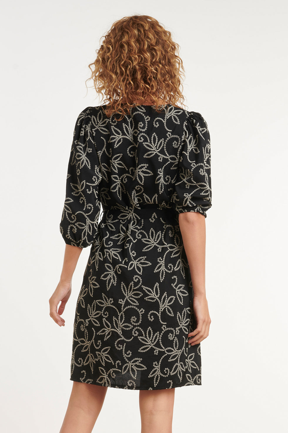 Black floral V-neck dress with waist belt and puff sleeves, above-knee length (back)