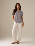 Gray women's polo shirt with button placket and short sleeves, collared neckline