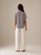 Gray women's polo shirt with short sleeves and collar, back view