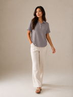 Gray women's polo shirt with short sleeves and button placket, full front