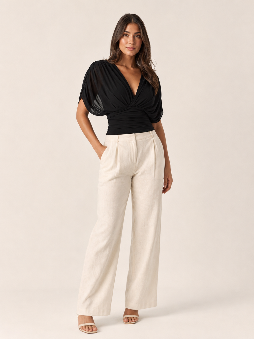 Black V-neck draped blouse with puff sleeves and ruched wrap front