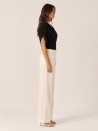 Black V-neck draped blouse with draped puff sleeve and ruched wrap bodice (side view)