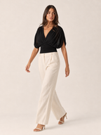 Black V-neck draped blouse with puff sleeves and ruched wrap front (full length)