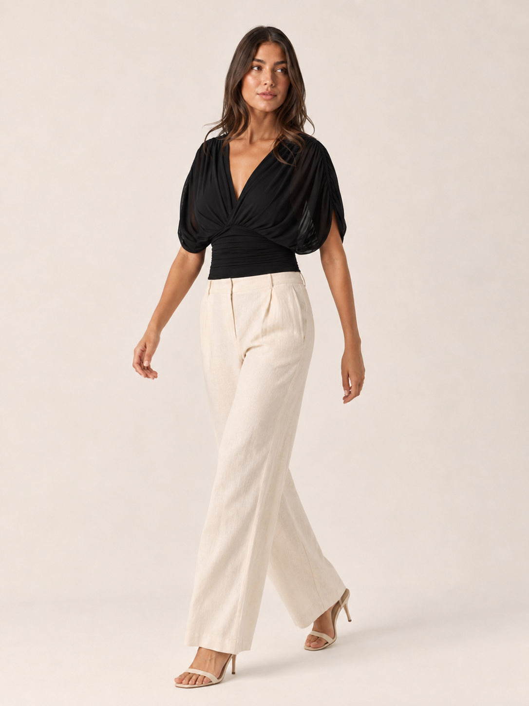 Black V-neck draped blouse with puff sleeves and ruched wrap front (full length)