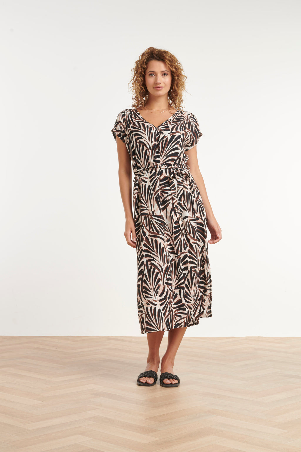 Palm print maxi dress with V-neck, short sleeves, and waist belt in cream and dark brown.