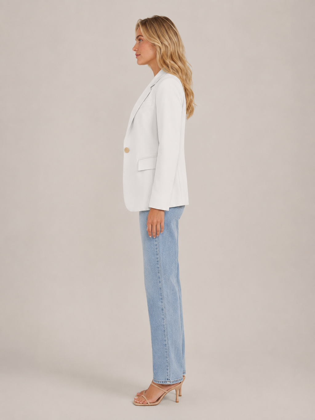 White fitted blazer side view with classic lapels and flap pocket