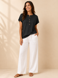 Black split-neck womens top with front button placket, short sleeves, loose fit