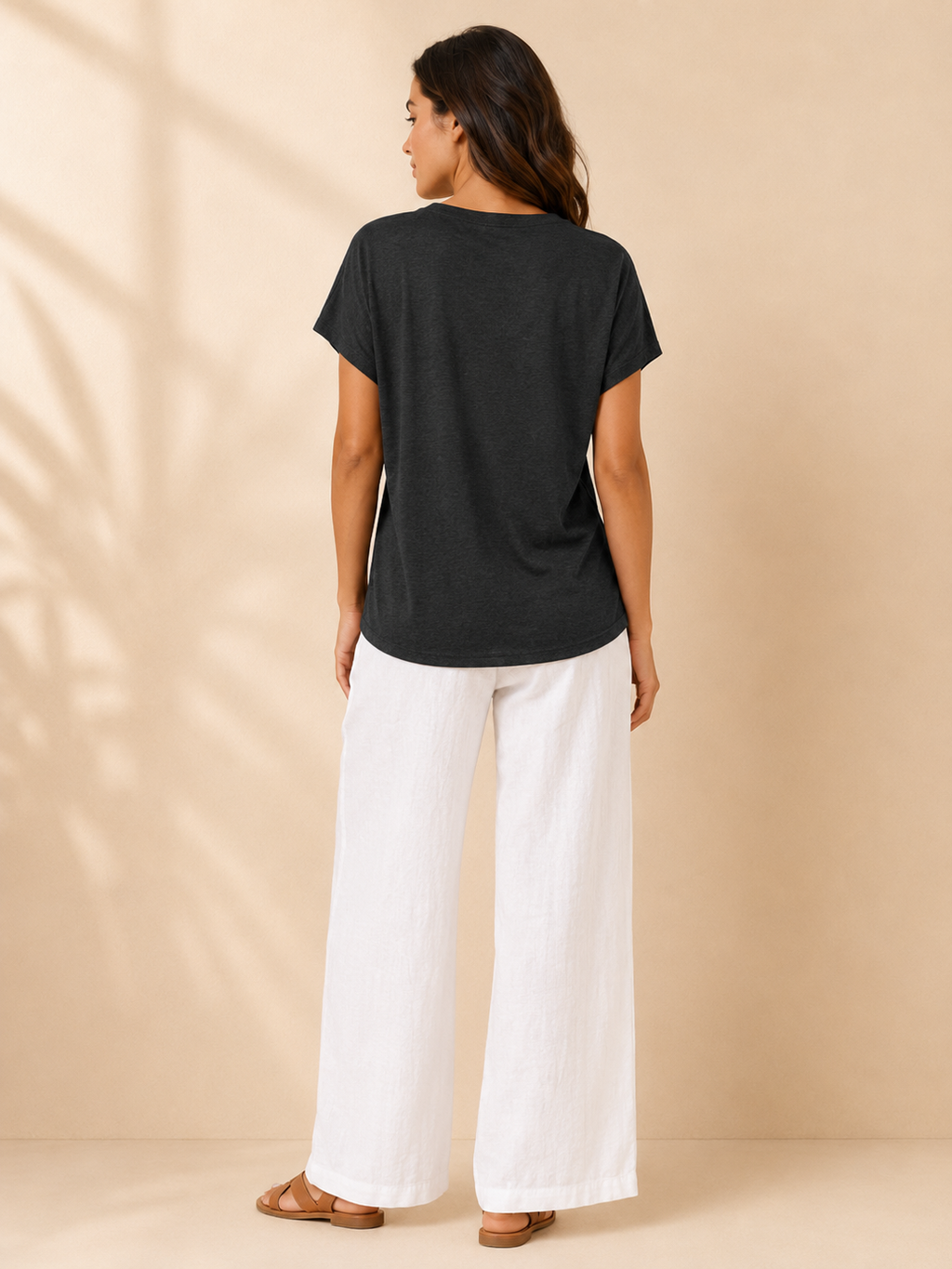 Black womens top with split neckline and short sleeves, shown from the back