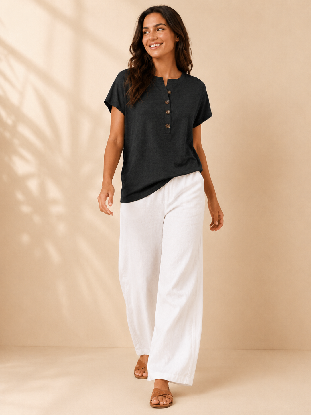 Black womens split-neck top with button placket and short sleeves, loose relaxed fit