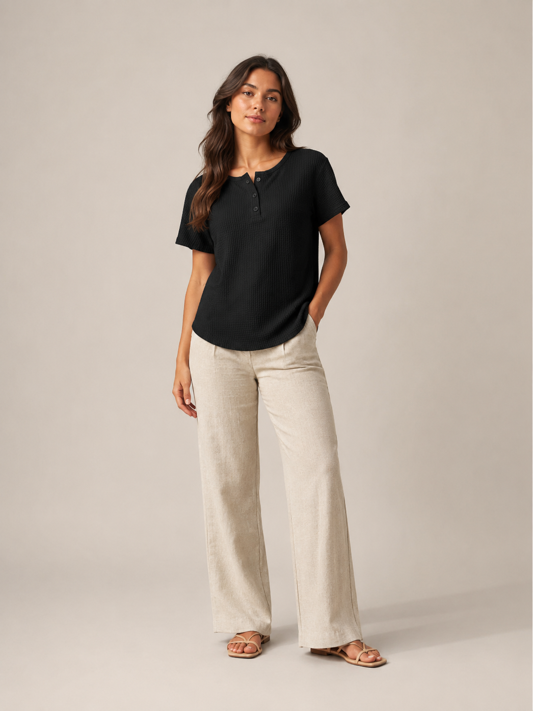 Women’s black short-sleeve button henley top with small button placket at crew neckline