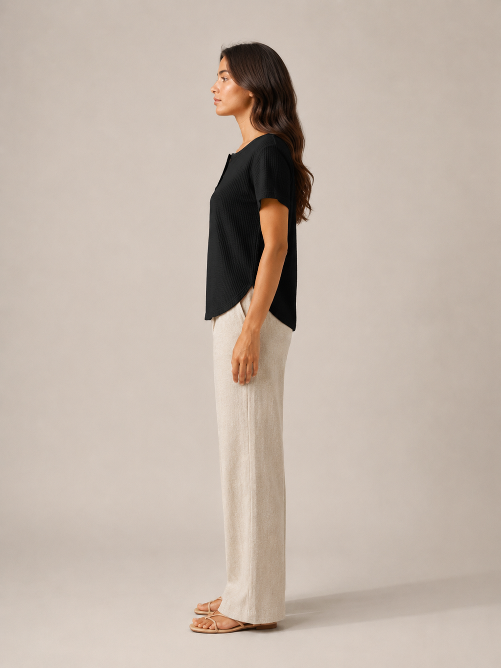 Women’s black short-sleeve button henley top from side view with buttoned neckline