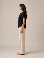 Women’s black short-sleeve button henley top from side view with buttoned neckline