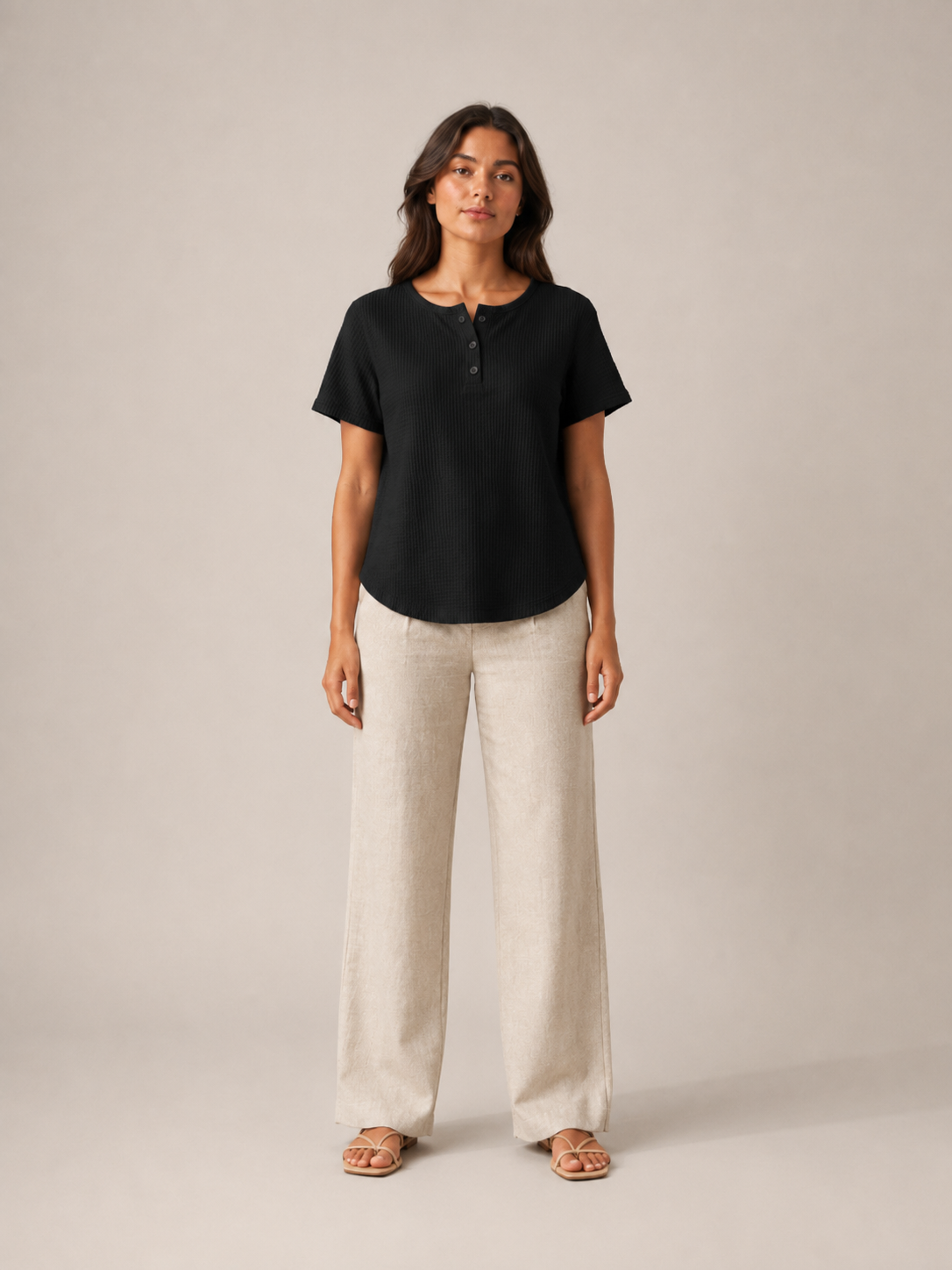 Women’s black short-sleeve button henley top shown front view with small button placket
