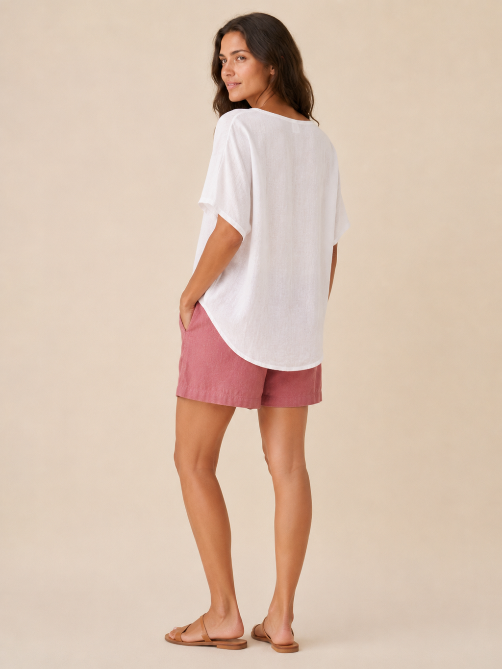 Women’s loose V-neck top in white, shown from back with short wide sleeves.