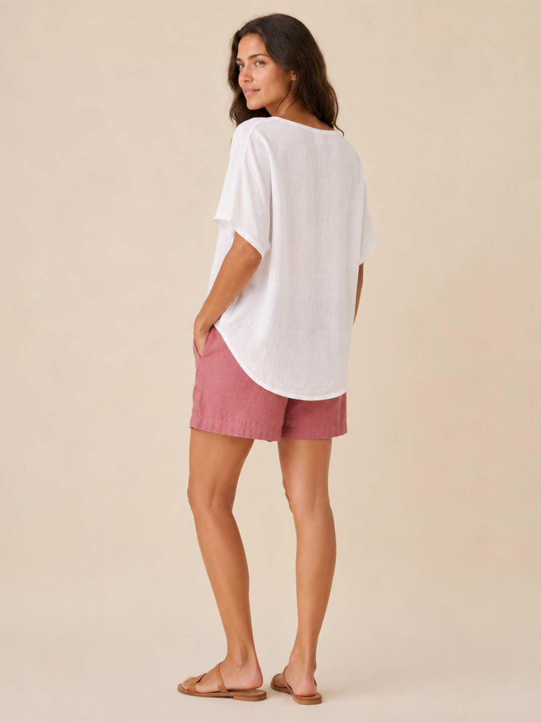 Women’s loose V-neck top in white, shown from back with short wide sleeves.