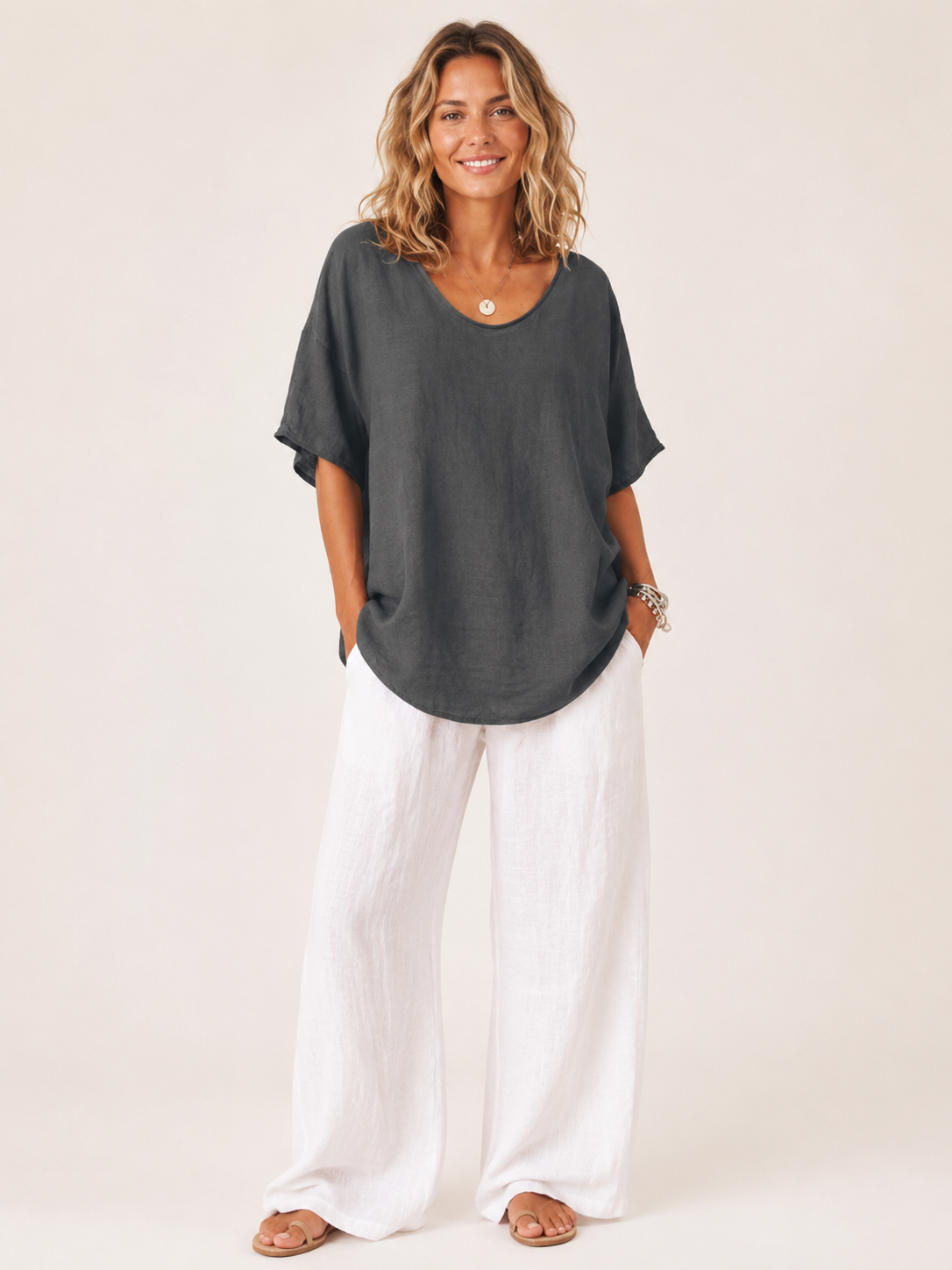 Women’s loose V-neck top in dark gray with short wide sleeves and relaxed drape.