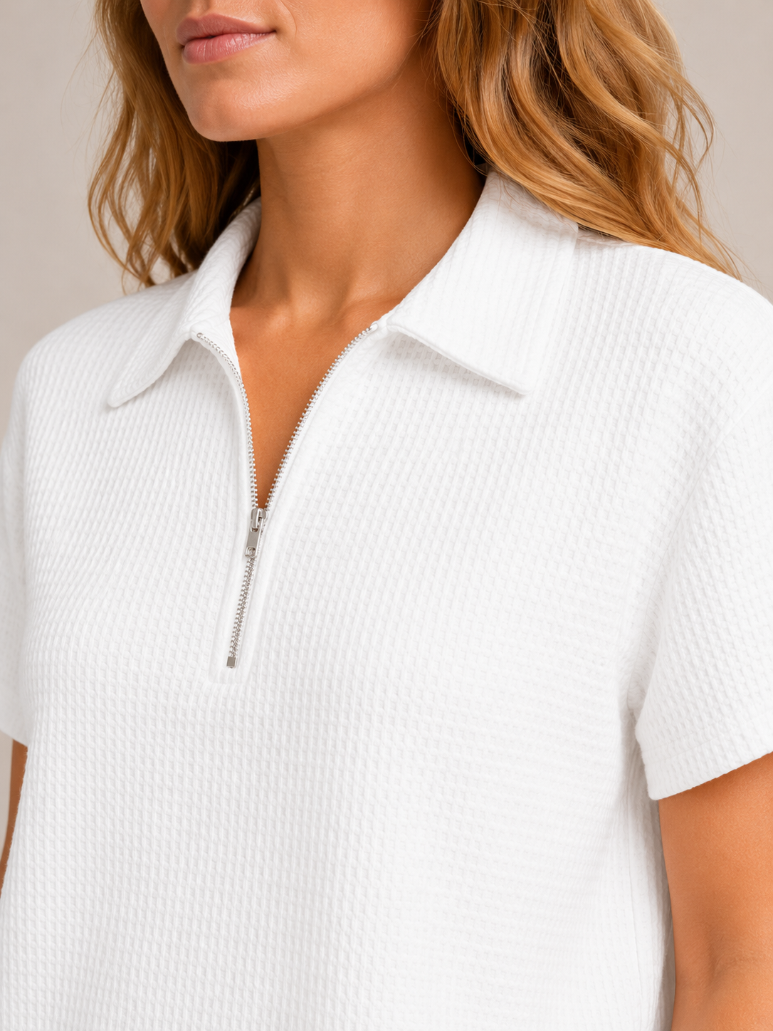 White women's waffle zip polo top close-up: stand collar and half-zip