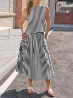 Black and white striped sleeveless midi dress with waist tie and tiered skirt